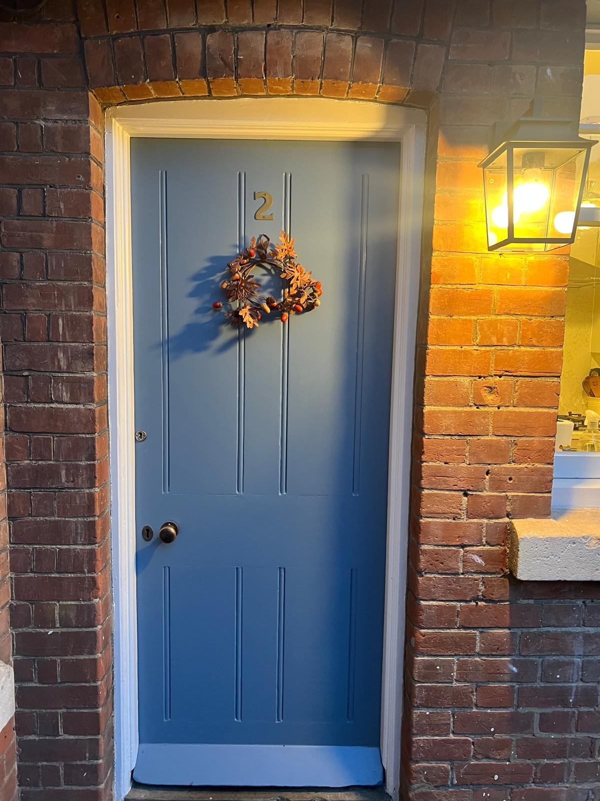 Blue front door with exterior lantern light