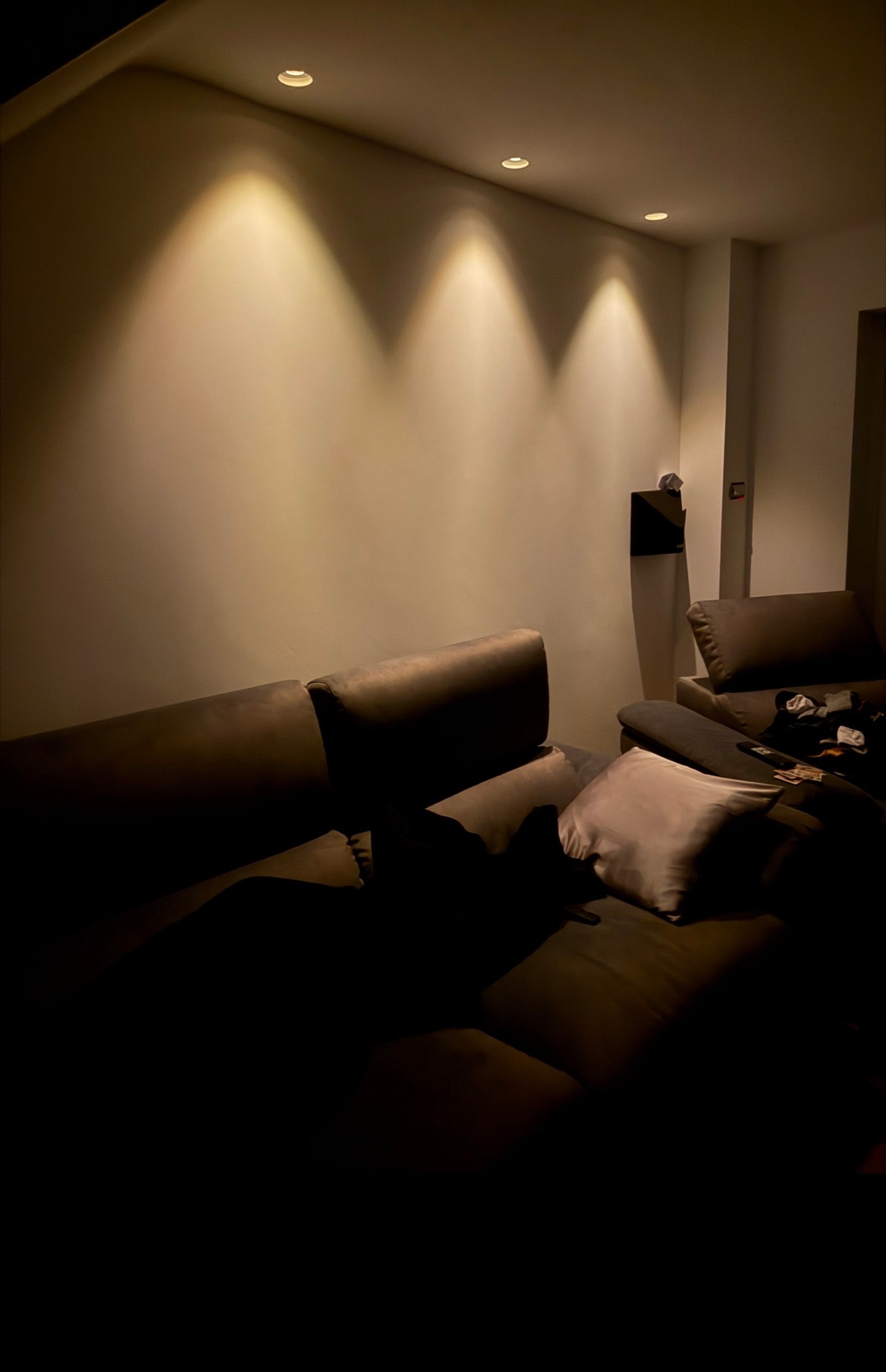 Home cinema room with warm downlights
