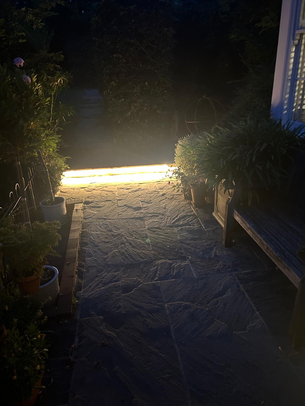 Garden path illuminated with LED strip lighting at night