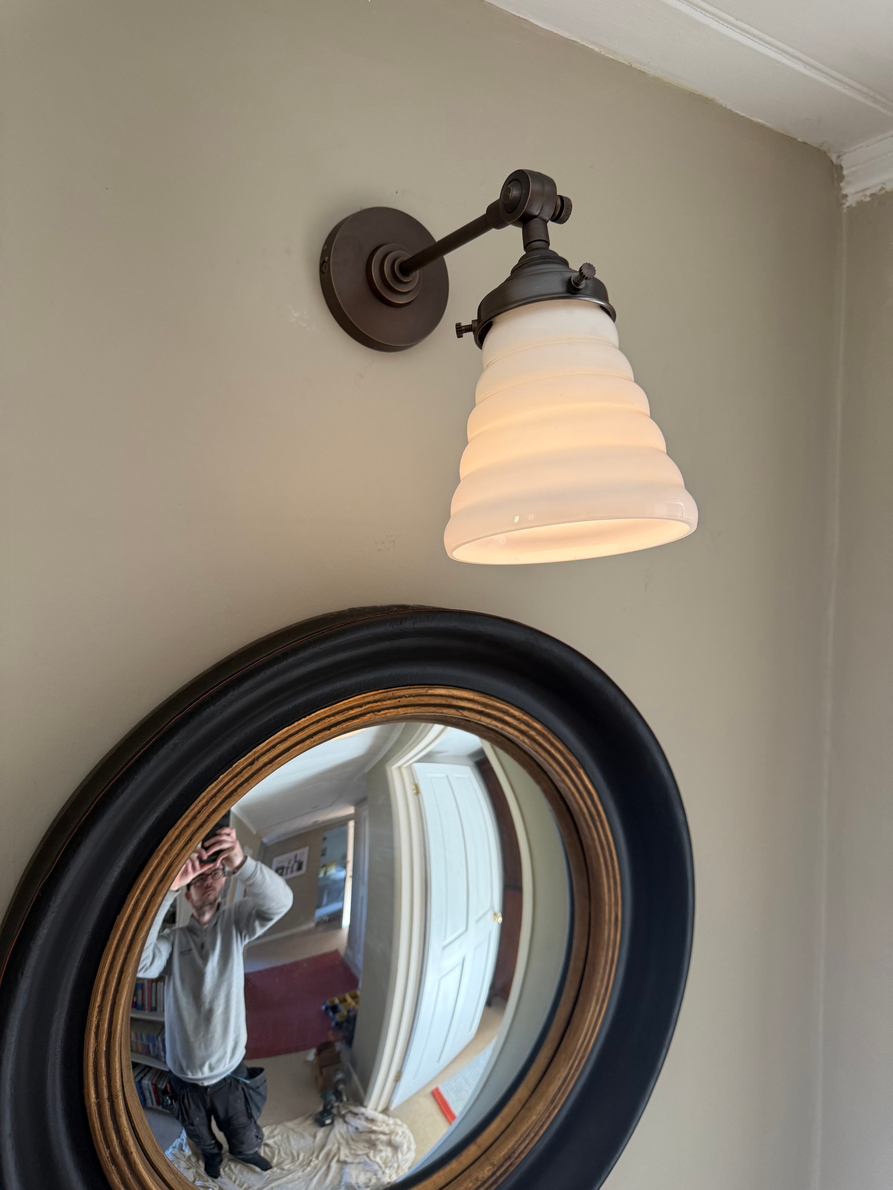 Hallway wall sconce with convex mirror