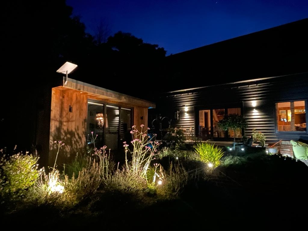 House and garden with architectural lighting at night