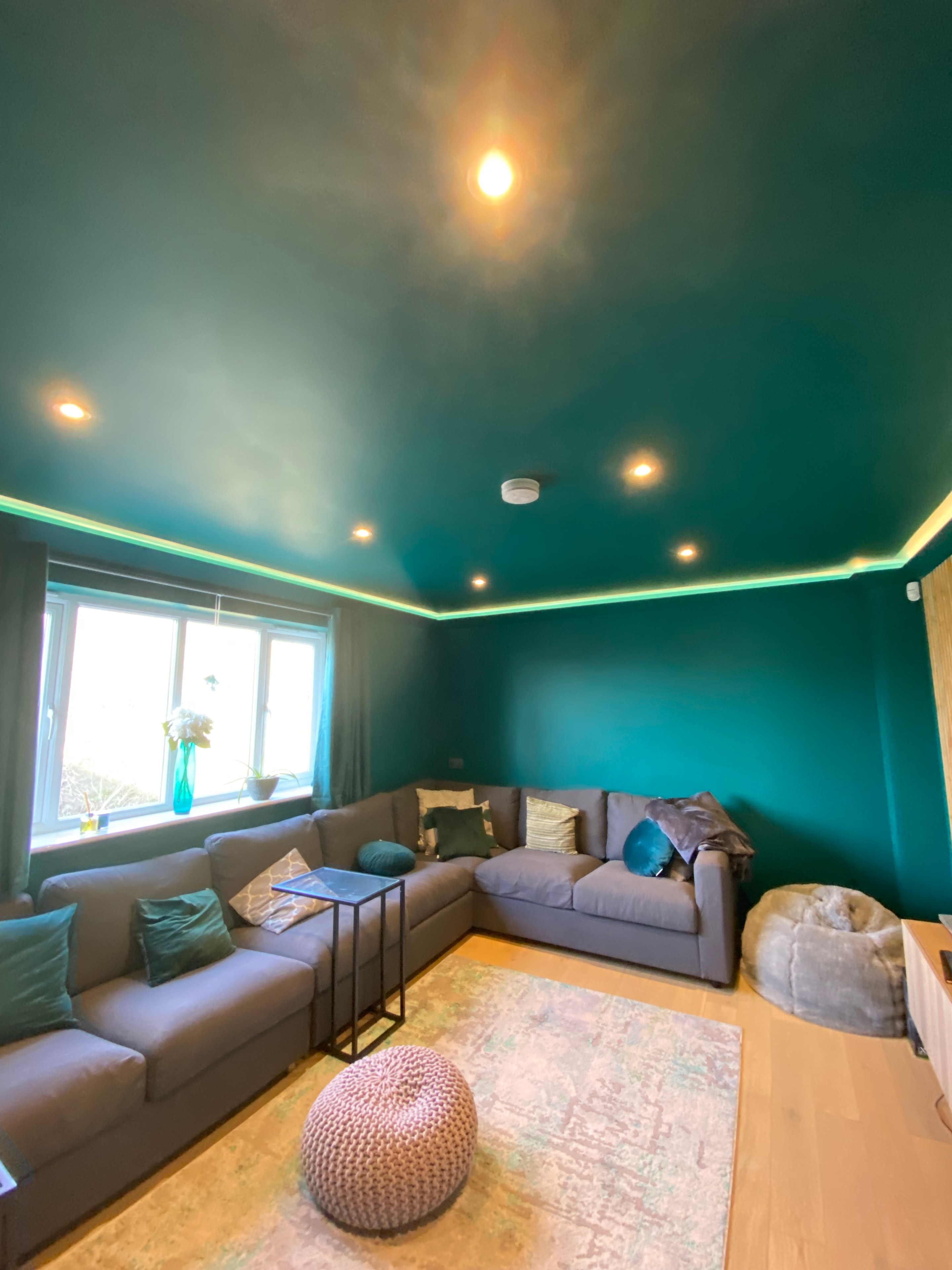 Teal lounge with LED cove lighting and downlights