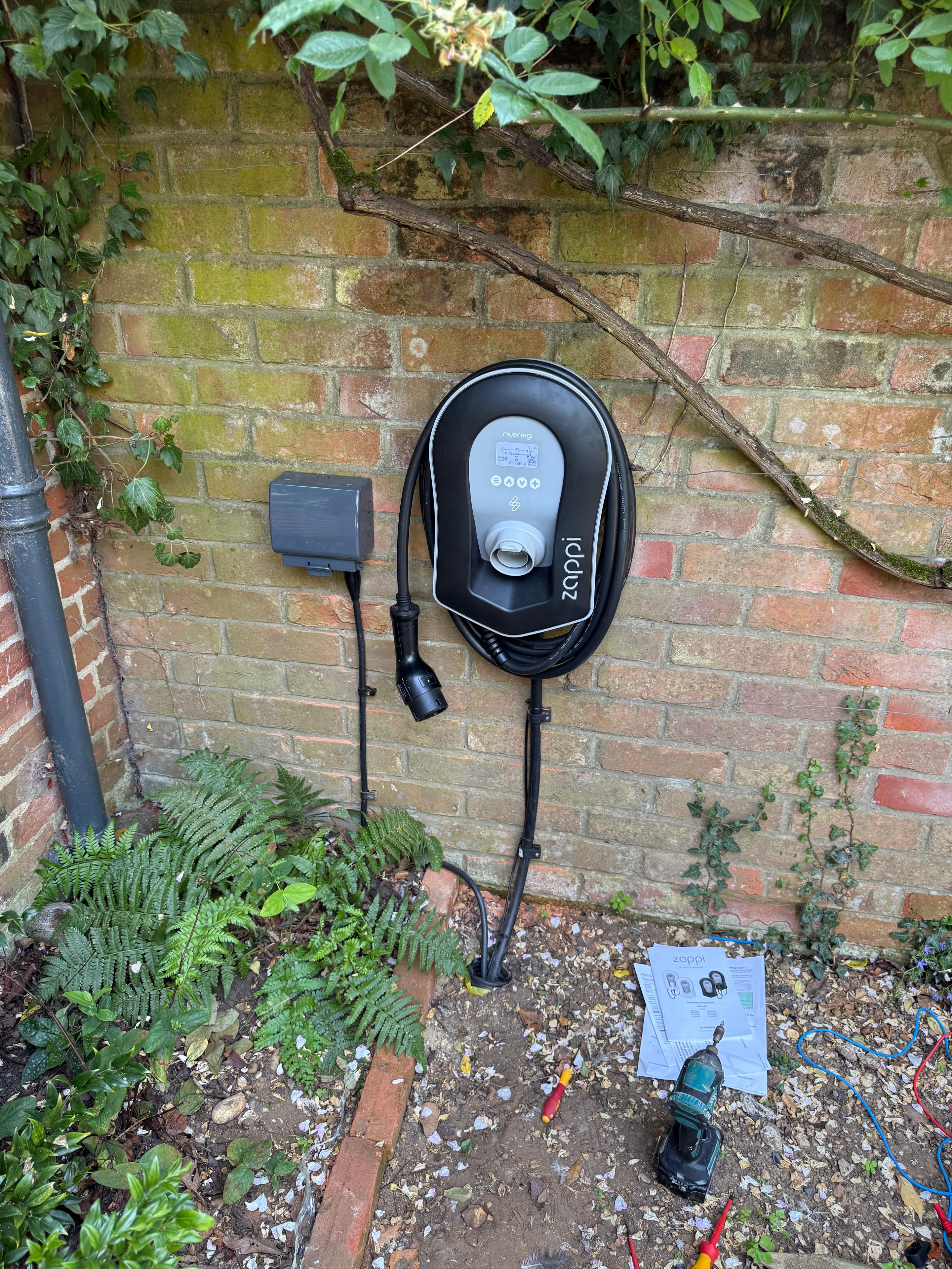 Zappi EV charger installed on brick wall